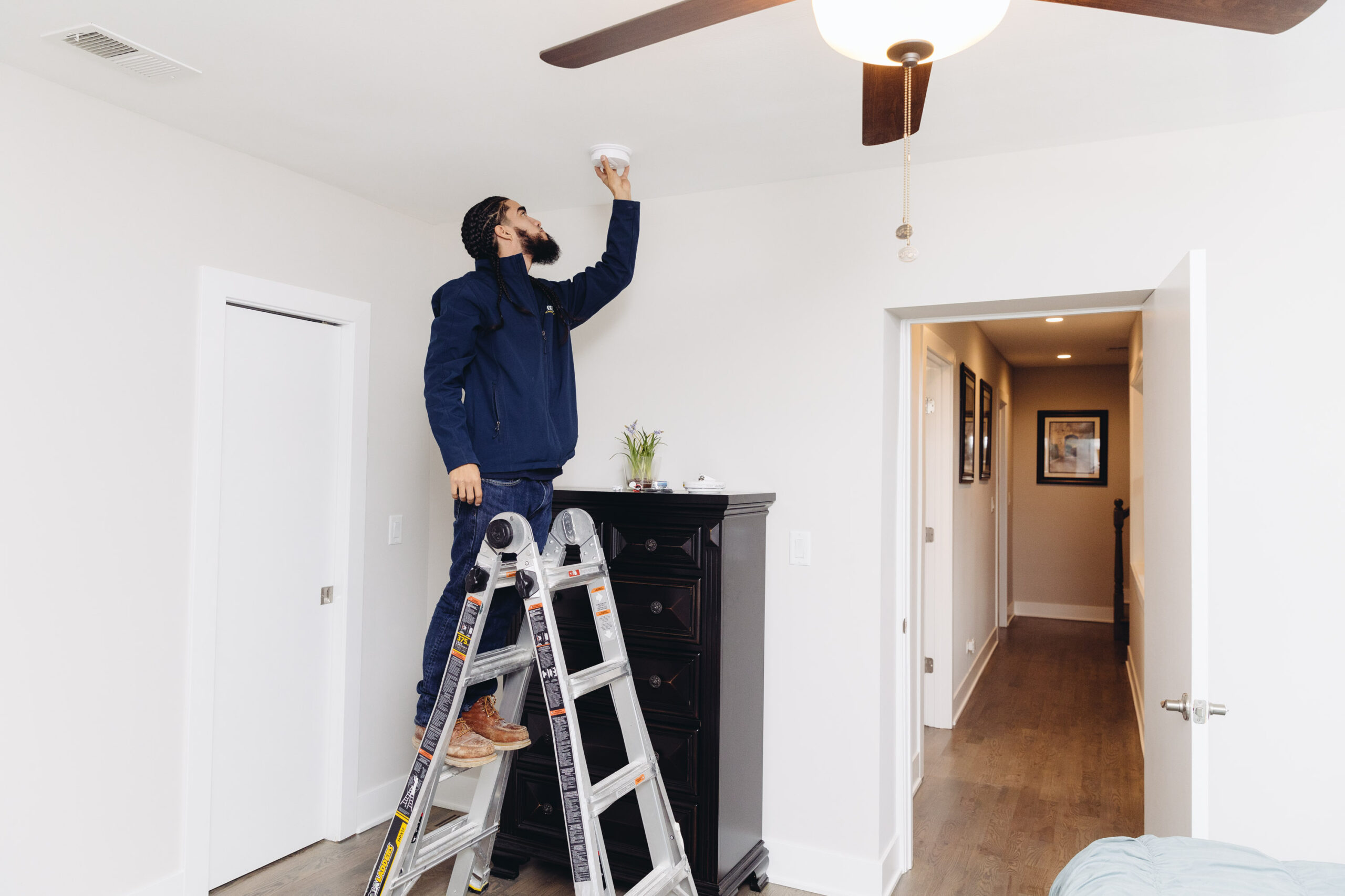 Fixer installing a smoke detector