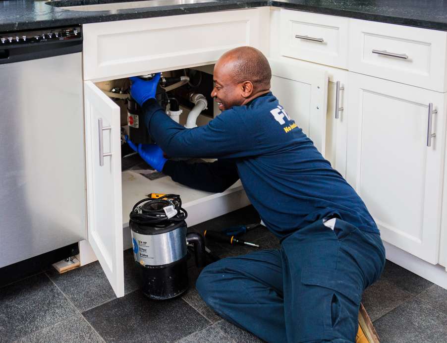 Fixer professional working in a home